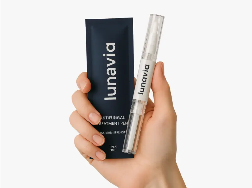 Hand holding antifungal treatment pen and packaging.